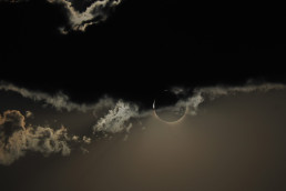 Solar eclipse behind clouds